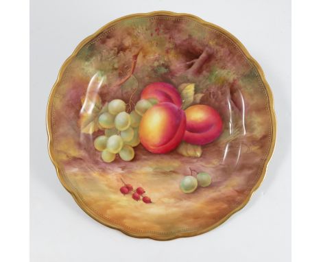 A Royal Worcester cabinet plate, decorated with fruit to a mossy background by H H Price, to a shaped gilt edge, diameter 9in