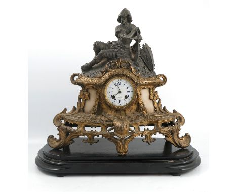 A 19th century gilt metal and metal mantle clock, with circular enamel dial, Henri Marc of Paris, surmounted by a figure hold