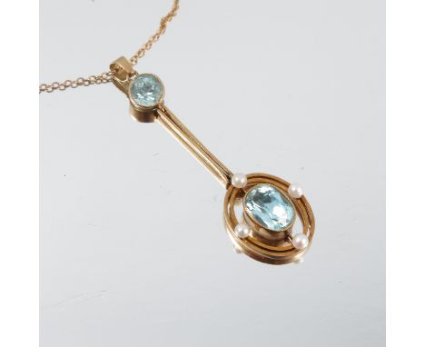 An Edwardian aquamarine and seed pearl pendant, stamped '9ct', the oval cut stone suspended within an oval with seed pearls a