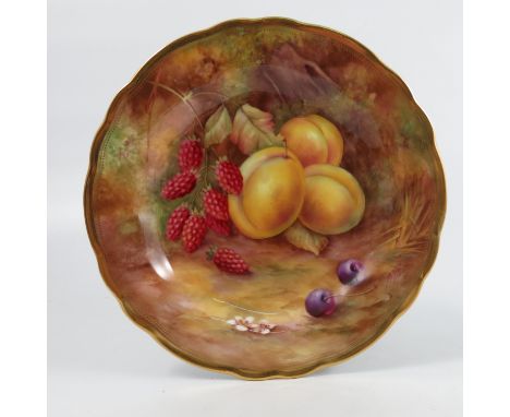 A Royal Worcester cabinet plate, decorated with fruit to a mossy background by H H Price, to a shaped gilt edge, diameter 9in