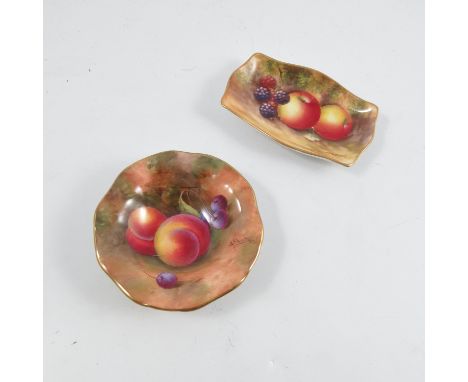 A Royal Worcester circular dish, decorated with fruit to a mossy background by A Shuck, with shaped edge and raised on a circ