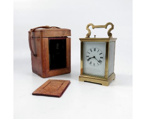 A brass cased repeating carriage clock, with white enamel dial and Roman numerals, height including handle 7.25ins, together 