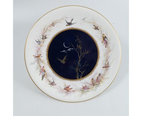 A Royal Worcester plate, decorated all around with wild birds attributed to Charley Baldwyn, the blue and gilt centre with a 