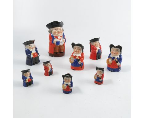 A collection of Royal Worcester Toby Jugs, decorated in bright enamels with red or blue coats, comprising one large Mr Toby, 