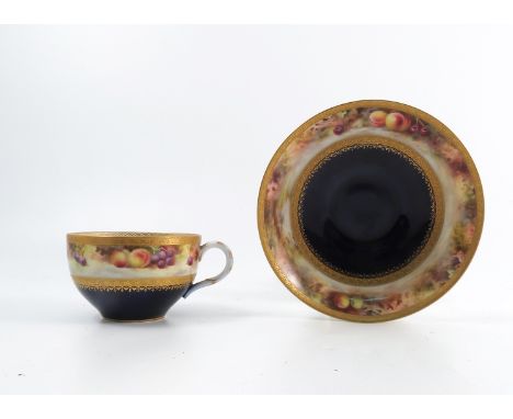 A Royal Worcester cabinet cup and saucer, decorated with a band of fruit to a mossy background by F Roberts, with gilt border
