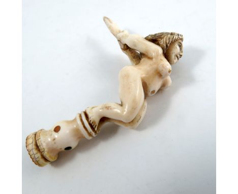 An early 19th century sailor's carved ivory pipe stopper or tamper, fashioned as a naked figurehead