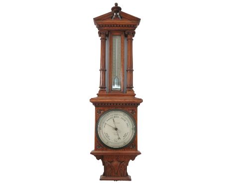 An oak cased barometer, with mercury filled thermometer, flanked by columns, the barometer dial inscribed Callaghan London, i