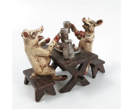 A Bergman cold painted bronze model, of two pigs seated at a table with pint glasses in their trotters with a jug and food on