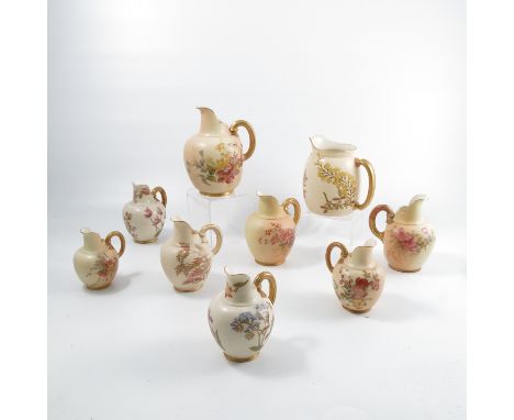 A Royal Worcester old ivory jug, decorated with wisteria, together with eight flat backed ivory jugs decorated with plants, s