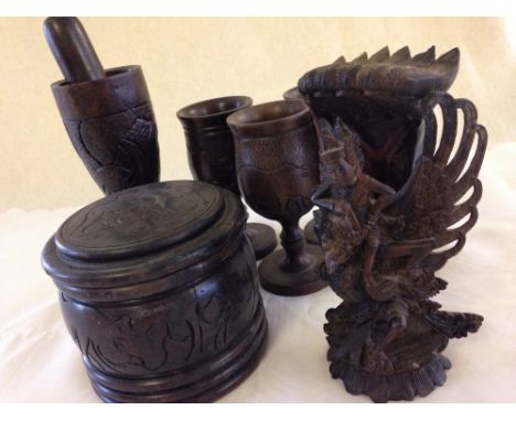 A quantity of South African treen items carved with animals to include a Pestle & Mortar, 4 goblets, and coaster set together