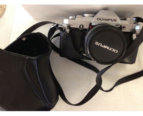 An Olympus OM30 SLR camera with 150mm lens.