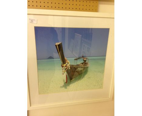 A large framed & glazed print of a tropical boat & beach scene. 58 x 58cm.