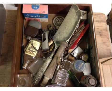 A wooden box containing assorted items including hip flask, Victorian padlock and assorted vintage bottles.