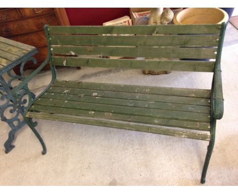 A garden bench with green cast iron ends and wooden slats. 122cm wide.