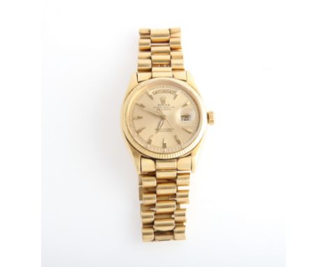 A gents 1970s Rolex Oyster Perpetual Day Date wrist watch, the gold-tone dial having hourly arrow markers with minute track b