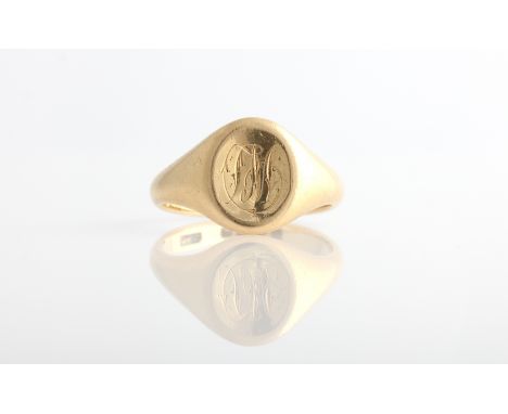 An 18ct yellow gold signet ring, the oval head engraved with monogram, hallmarked Chester 1916, ring size Q.