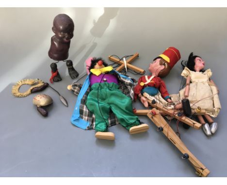A Japanese windup walking black doll, Pelham puppet, Pelham soldier, with another puppet.