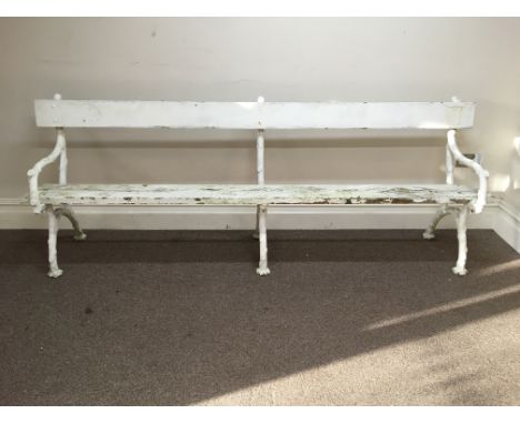 A white painted iron framed bench.