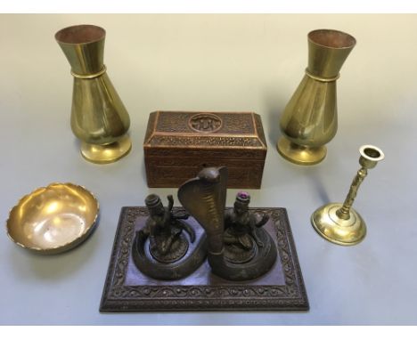 A candlestick holder with brass cobra and Hindu gods, a wooden carved design box, two vases, a candlestick and bowl.