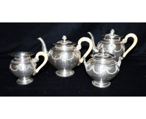 BELLE EPOQUE FRENCH SILVER TEA SERVICE Of baluster form, decorated with engine turning and embossed floral swags, Sevigne bow