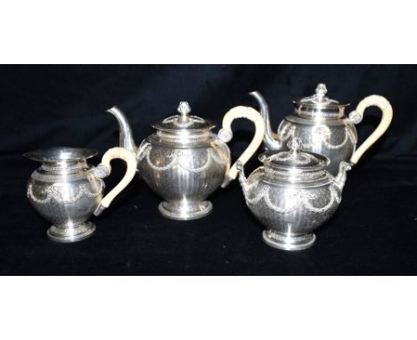 BELLE EPOQUE FRENCH SILVER TEA SERVICE Of baluster form, decorated with engine turning and embossed floral swags, Sevigne bow