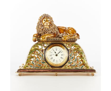 Jay Strongwater, United States. Gilt metal mantel clock with a form of a recumbent lion along the top. Stamped along the unde