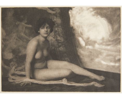 Frank Eugene (American, 1865-1936). Sepia platinum print photograph of a nude woman seated and posed in front of a tapestry o