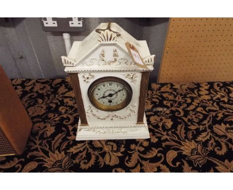An early 20thC ceramic mantel clock, the floral enamel dial with Arabic numerals