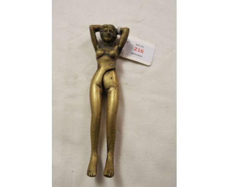 A brass nutcracker in the form of a reclining lady   15 cm high