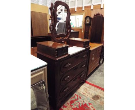 A 19thC mahogany dressing chest the top having cartouche shaped framed mirror above a central marble tile, flanked by two sho