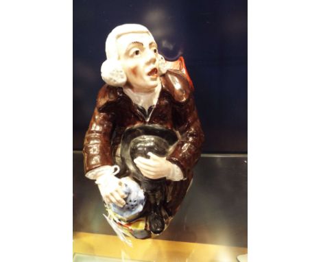 A 19thC Staffordshire pottery Toby jug in the form of a seated elderly gentleman with lantern 