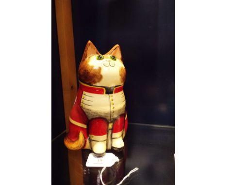 A large Joan De Bethel hand-painted ceramic cat having glass eyes with inscription to rear 'Light is the love of a soldier th