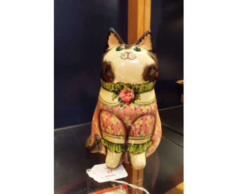 A large Joan and David de Bethel hand-painted ceramic cat with glass eyes and inscription to rear ' A hard beginning maketh a