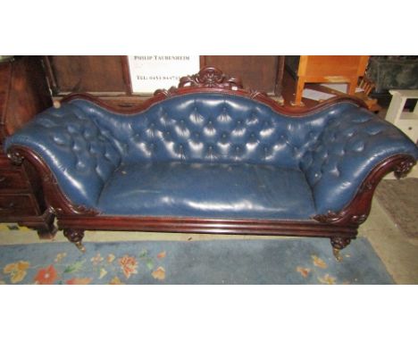 A 19th century mahogany double scroll arm three seat sofa with carved showwood frame, blue deep buttoned upholstery, raised o