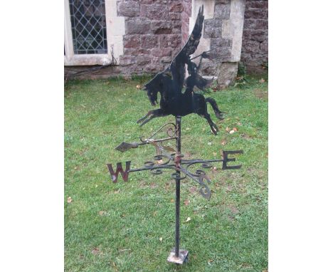 An iron work weather vane with cut sheet metal finial in the form of a winged Pegasus and rider with spear