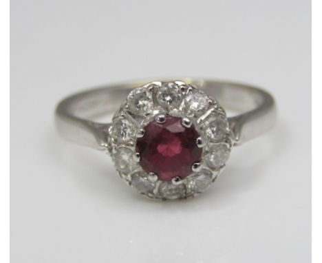An 18ct white gold ruby and diamond halo ring, size L, 3.2g