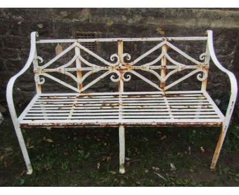 A Regency style iron work three seat garden bench with scrolled lozenge shaped panelled back, strap work seat, open down swep