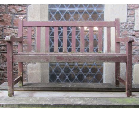 A weathered stained teak two seat garden bench with slatted seat and back with applied label to side rail Gloster