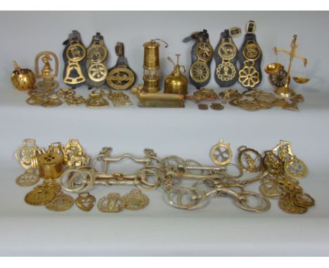 A large quantity of reproduction cast brass horse brasses, two bits, a small miners lamp, etc