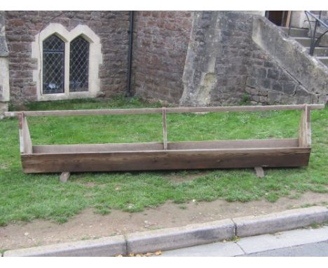 An unusual rustic weathered elm and pine two divisional trough with tapered frame and sledge supports, 11ft long approx