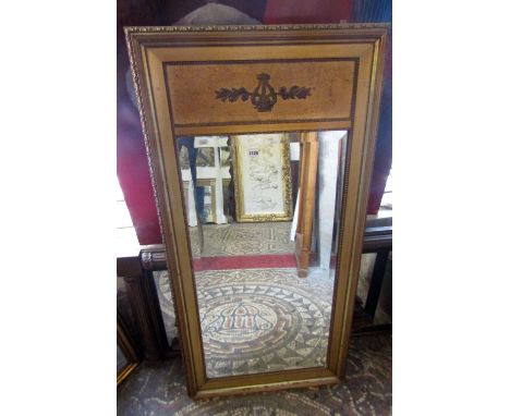 A gilt framed wall mirror of rectangular form with bevelled edge plate and classical detailing, 134 cm x 68 cm approx, togeth