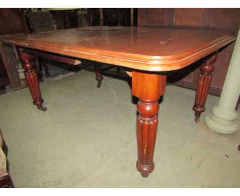 A Victorian mahogany wind-out extending dining table of rectangular form with single additional leaf, moulded outline and rou