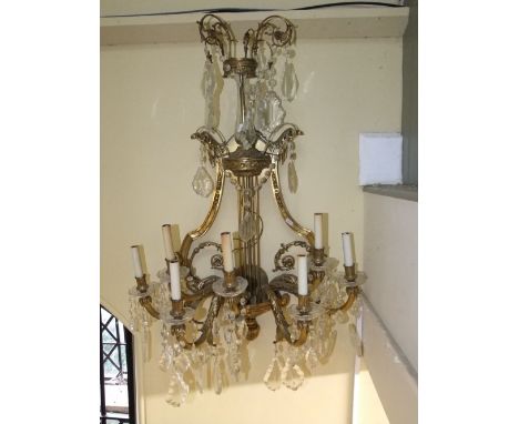 A substantial and good quality seven branch wall mounted light fitting, the back panel of lyre shape, the branches with acant