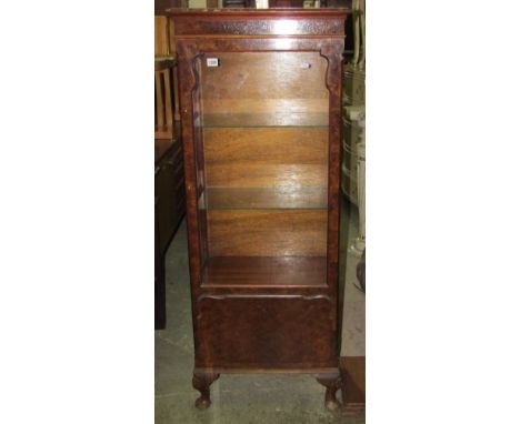 A reproduction Queen Anne style walnut veneered display cabinet, freestanding and enclosed by a shaped glazed panelled door r