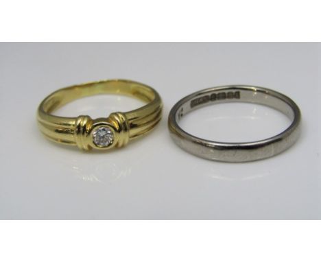 A contemporary diamond set ring in unmarked yellow metal, size K, together with an 18ct white gold wedding ring, size K/L, 4.