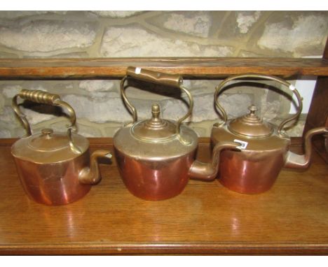 Three Victorian copper and brass kettles, slight varying in design, one with acorn finial, together with a Grimwade "Wisteria