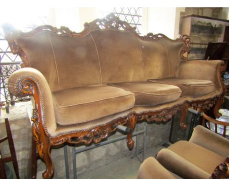 A reproduction three piece suite comprising three seat sofa and a pair of matching armchairs, with flamboyant show wood frame