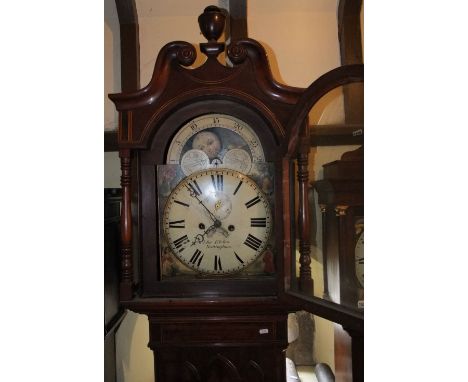 A substantial Regency mahogany longcase clock, the short door with lancet shaped outline, the hood with turned columns and sw