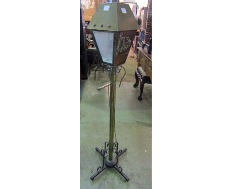 An Arts &amp; Crafts style standard lamp in the form of a street lantern, the square tapered hood partially glazed and enclos