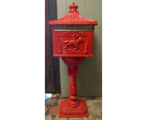 A reproduction cast light steel, red painted freestanding post box with pagoda shaped canopy and further detail, complete wit